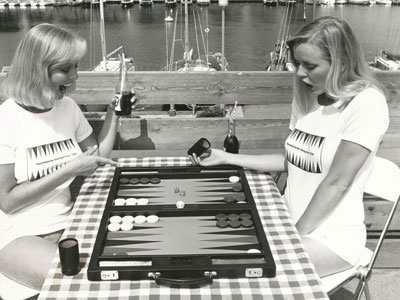 Publicity photo for Scandinavian Backgammon Club featuring twins Ingelise & Annelise Jantzen. Location: Hellerup Yacht Club, 1977.